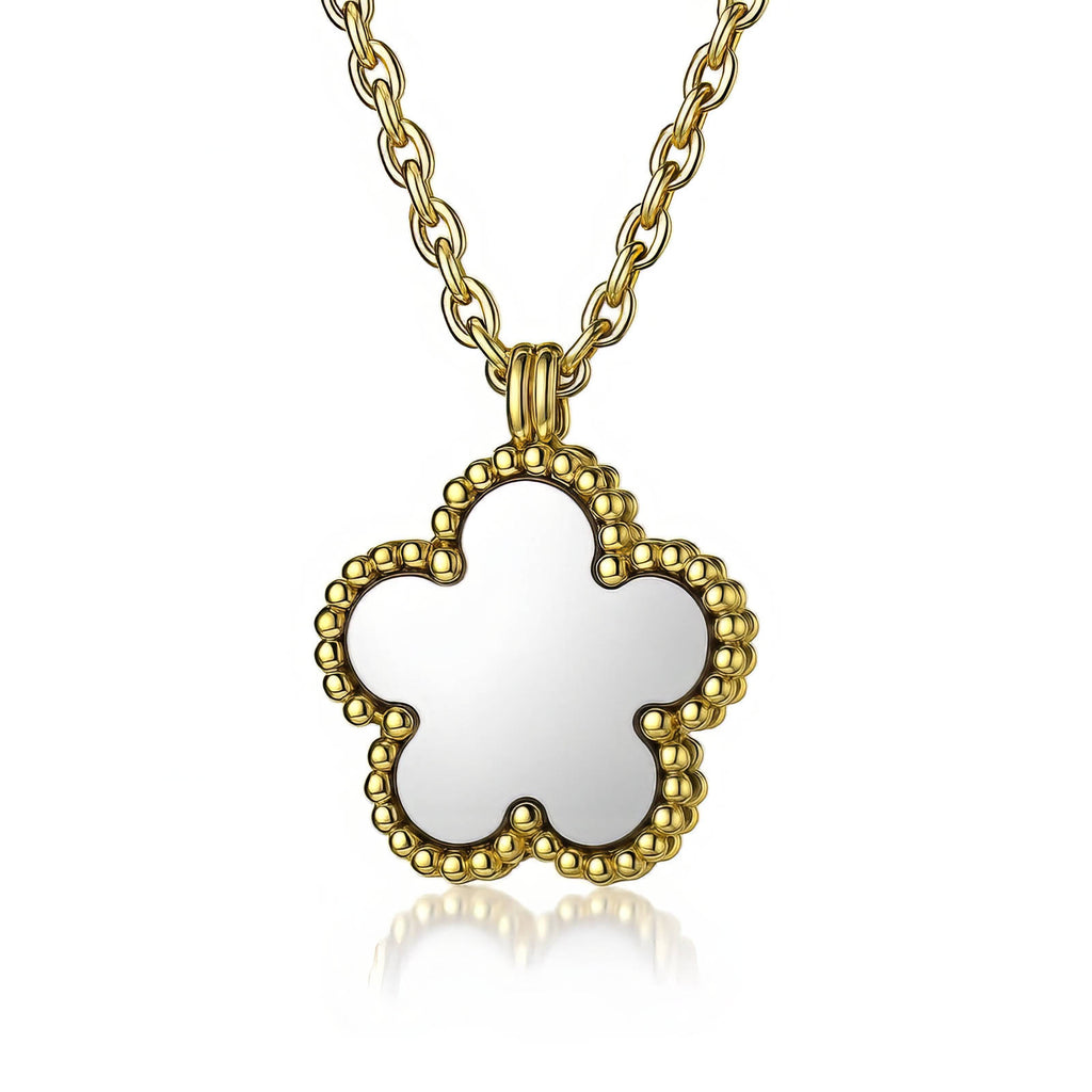 Gold necklace with a clover-shaped pendant on a white background