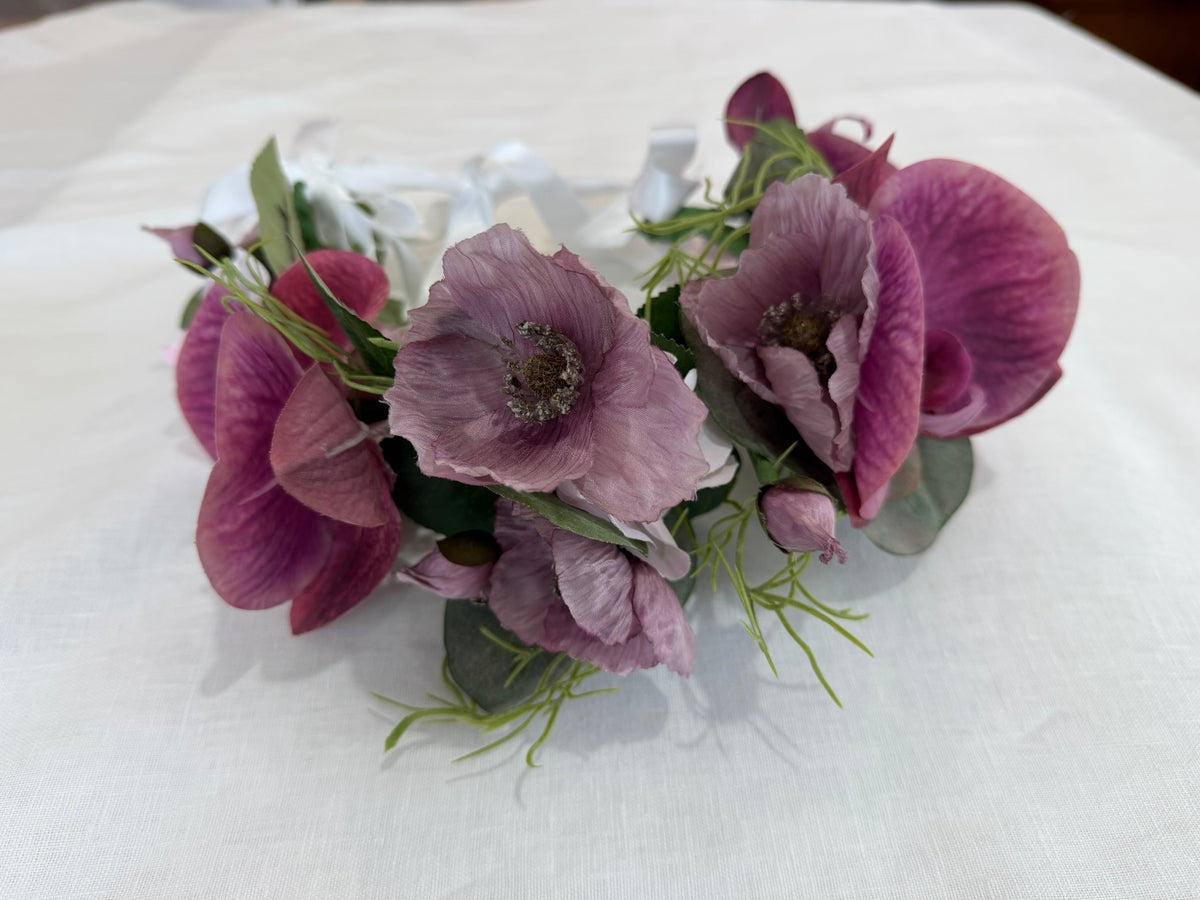 Floral headband with purple flowers on a white background