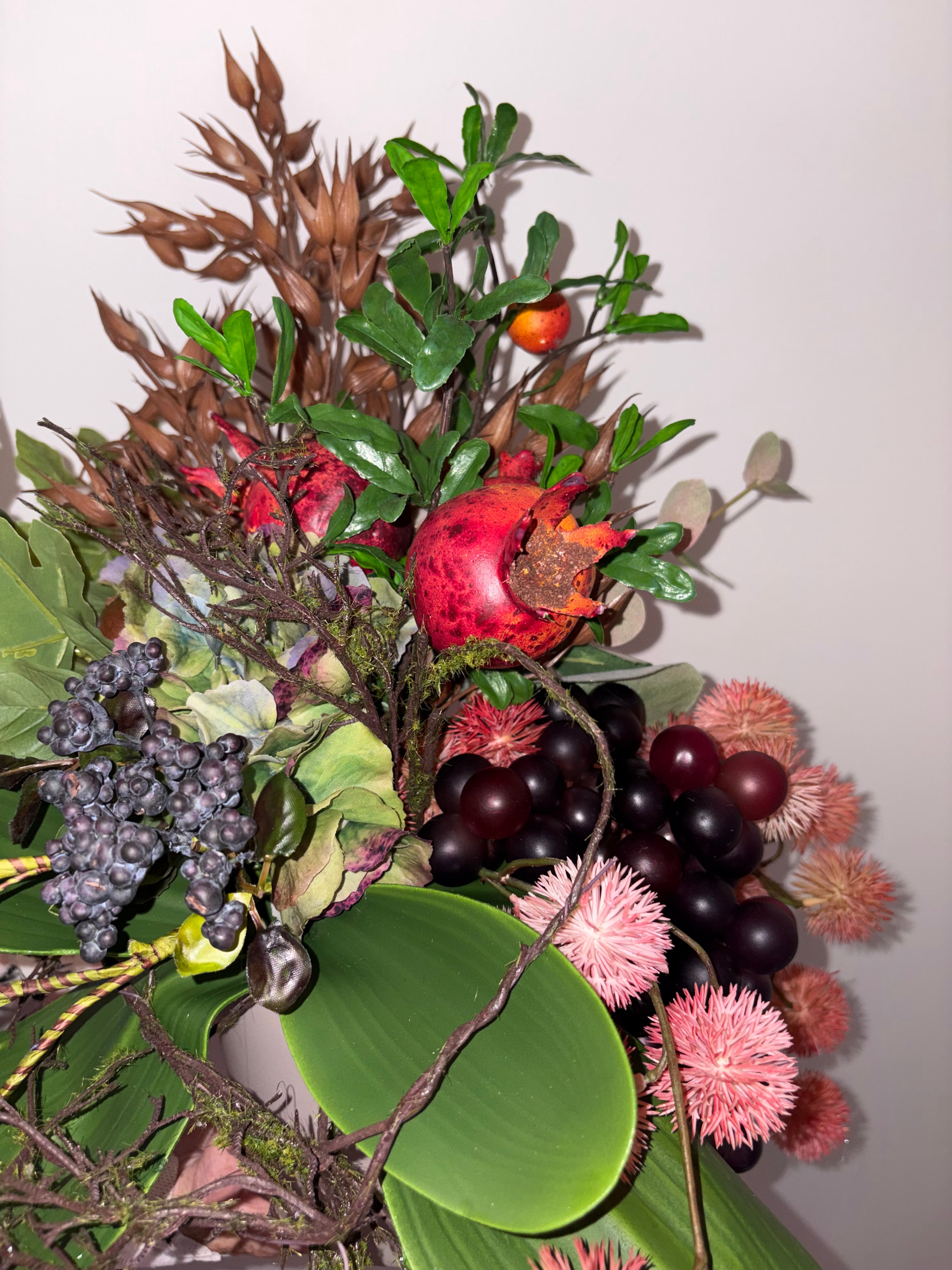 Pomegranate, Winter Berries and Dark Grape Arrangement