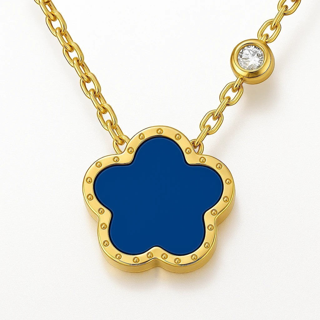 The Velvet Grove gold-tone floral pendant necklace with a deep blue center and a sparkling crystal station on the chain.