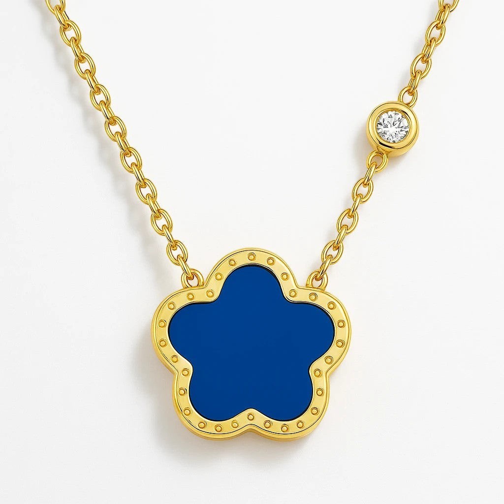 The Velvet Grove gold-tone necklace featuring a deep blue floral pendant and a single brilliant-cut crystal station.