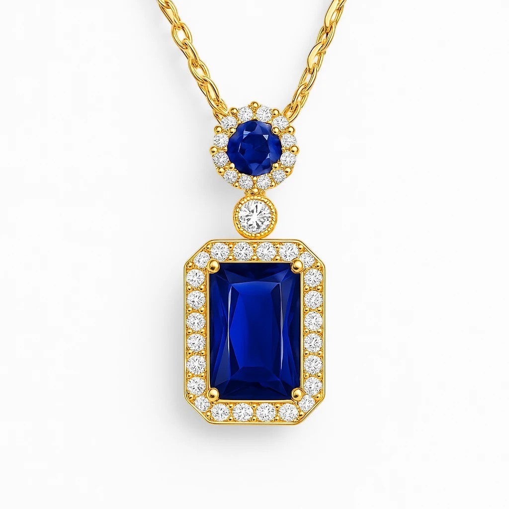 The Velvet Grove gold-tone necklace featuring a rectangular royal blue gemstone pendant with a shimmering crystal halo.
