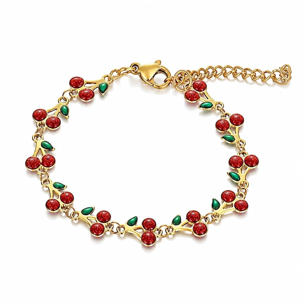 The Velvet Grove gold-tone link chain bracelet featuring red enamel cherry motifs with green leaves and lobster clasp.