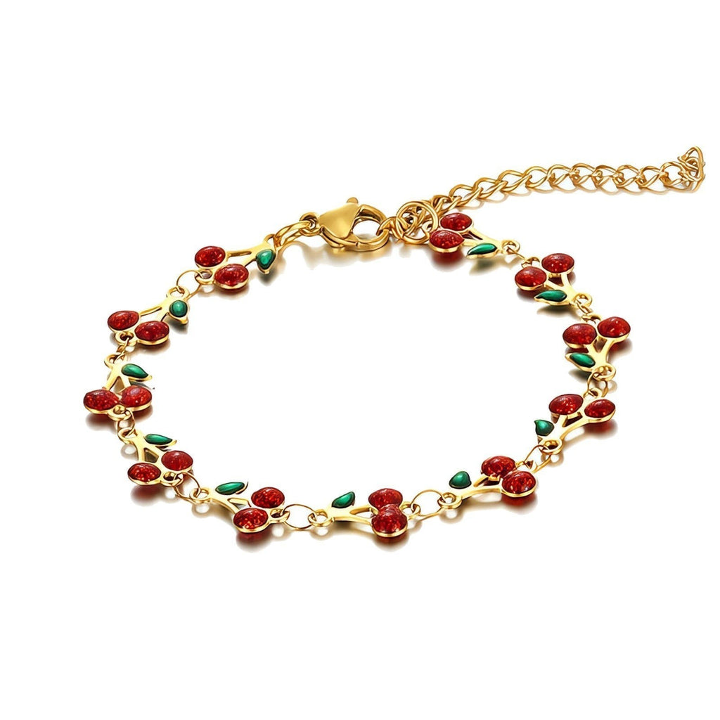The Velvet Grove gold-tone link chain bracelet featuring red enamel cherry motifs with green leaves.