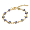 The Velvet Grove gold-tone chain bracelet featuring vibrant blue and yellow enamel daisy flower charms.