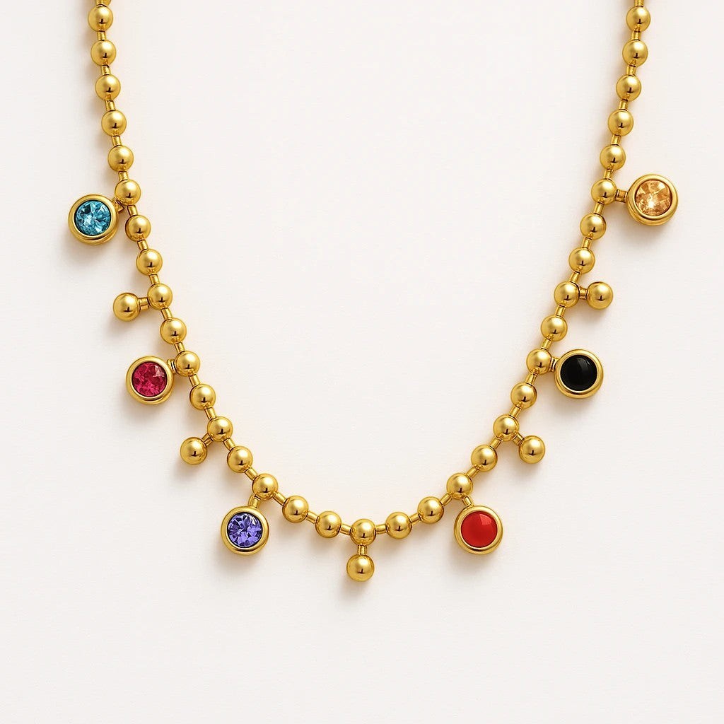 The Velvet Grove gold-tone ball chain necklace featuring bezel-set multi-colored crystal accents.