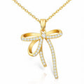 The Velvet Grove gold-tone bow pendant necklace featuring shimmering cubic zirconia stones on a delicate chain.