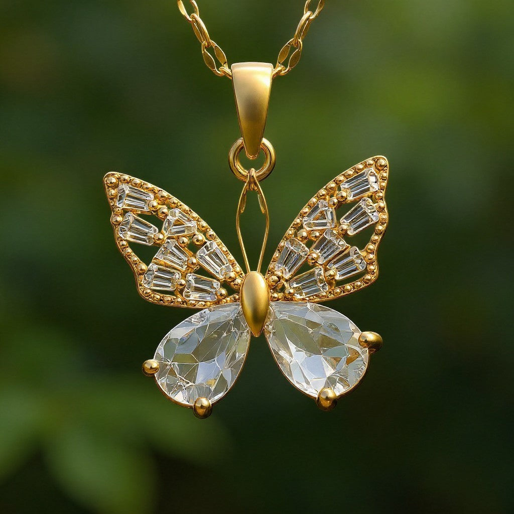 The Velvet Grove gold butterfly pendant necklace featuring sparkling baguette and pear-cut crystals on a delicate chain.