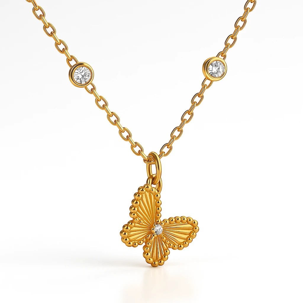 The Velvet Grove gold-tone butterfly pendant necklace with sparkling stone accents and bezel-set chain details.