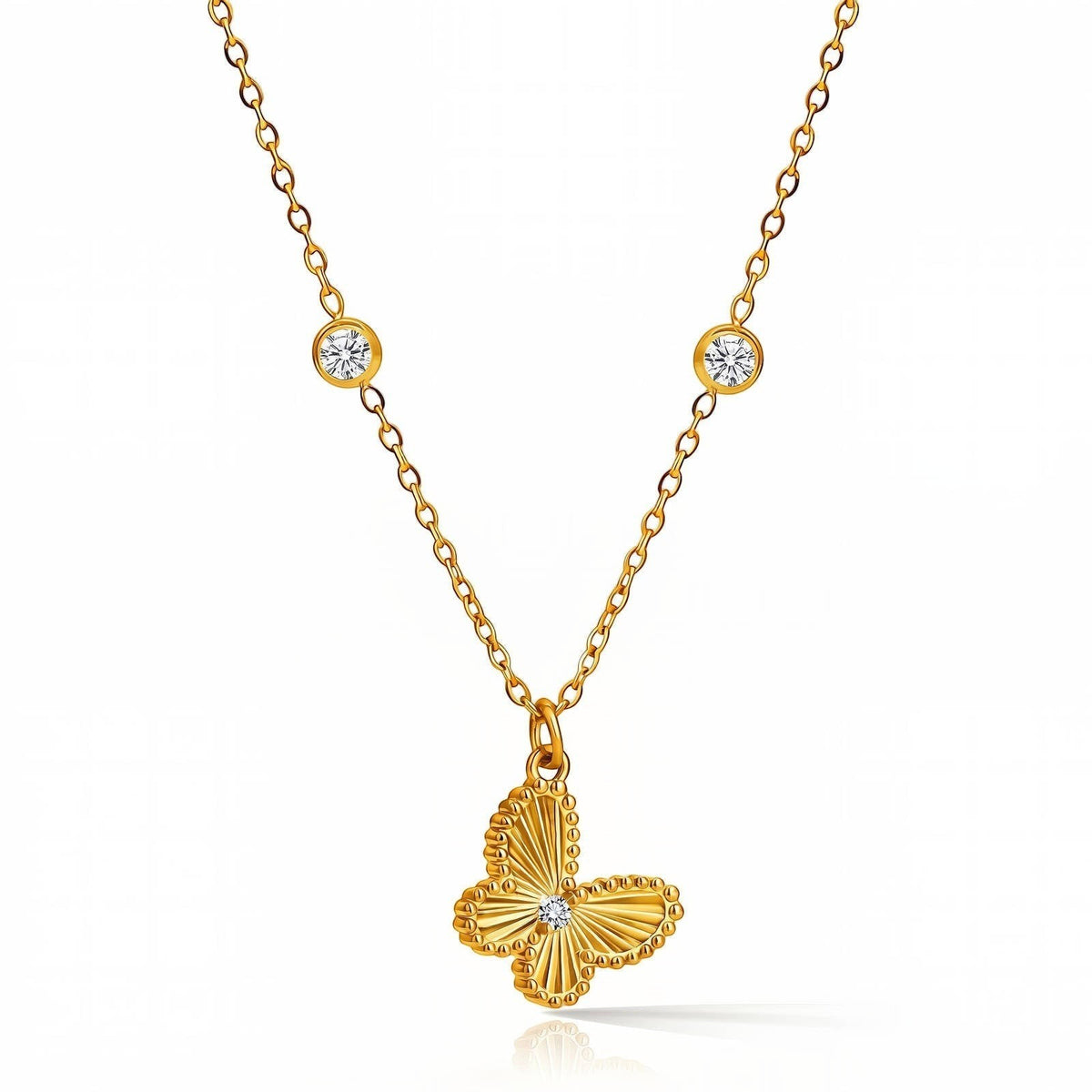 The Velvet Grove gold butterfly pendant necklace with textured wings, a central stone, and two bezel-set chain accents.