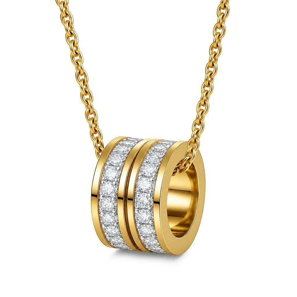 The Velvet Grove gold-tone cylindrical ring pendant necklace with shimmering pavé-set crystals on a delicate chain.