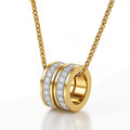 The Velvet Grove gold-tone cylindrical ring pendant necklace featuring pavé-set crystals on a delicate chain