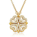 The Velvet Grove gold-tone clover pendant necklace featuring four heart-shaped petals encrusted with clear crystals.