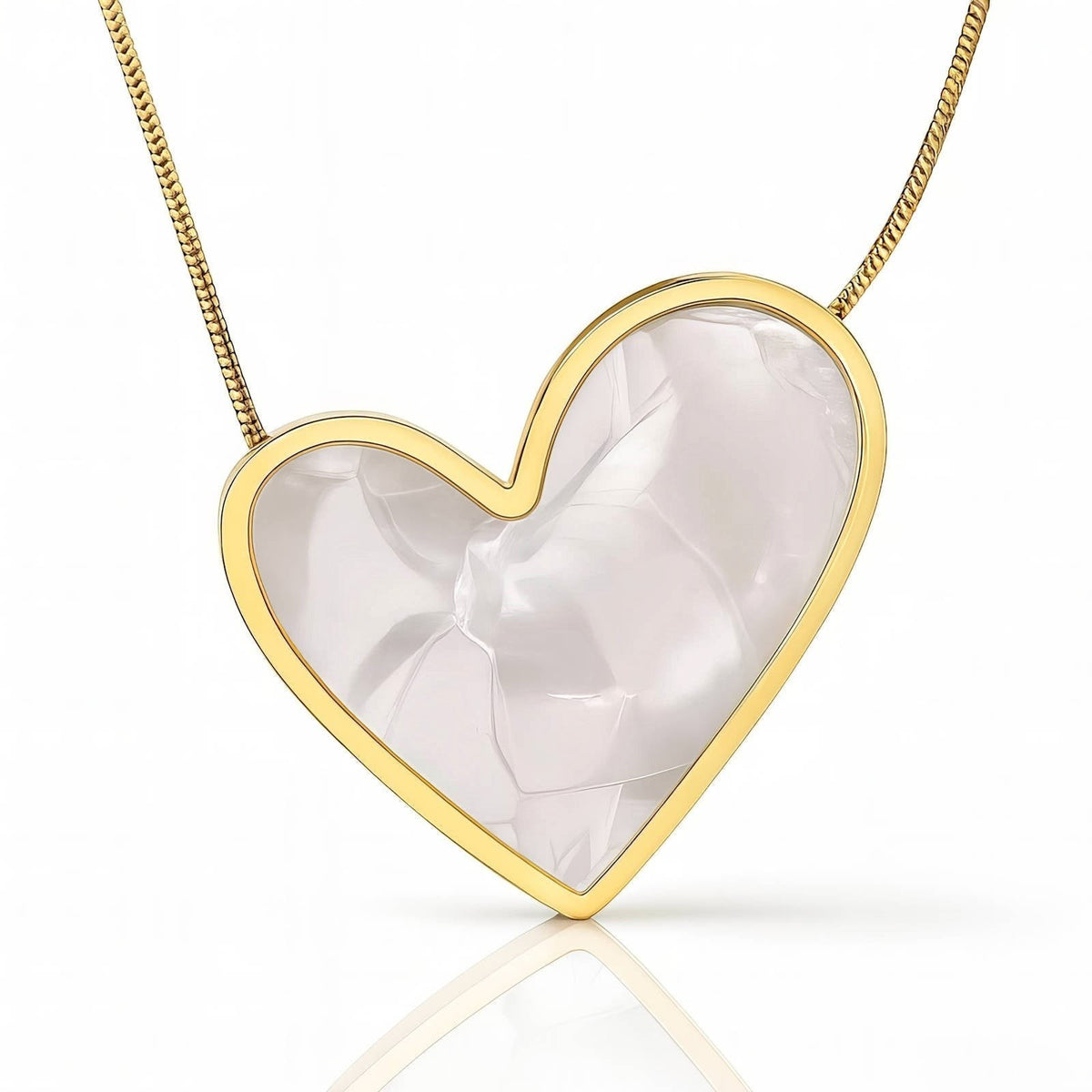 The Velvet Grove heart pendant necklace featuring a pearlescent inlay in a polished gold-tone frame on a delicate chain