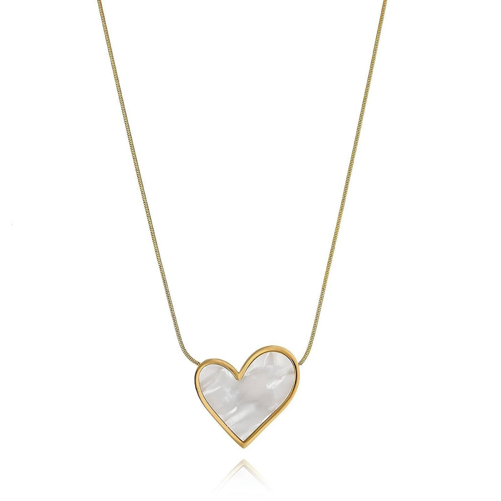 The Velvet Grove heart pendant necklace featuring a pearlescent inlay in a polished gold-tone frame on a delicate chain.