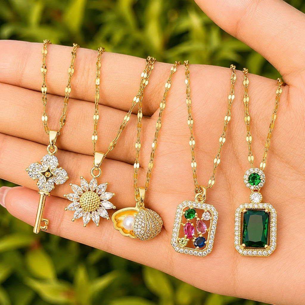 The Velvet Grove gold-tone necklace set featuring five unique pendants including an emerald-green rectangular stone.