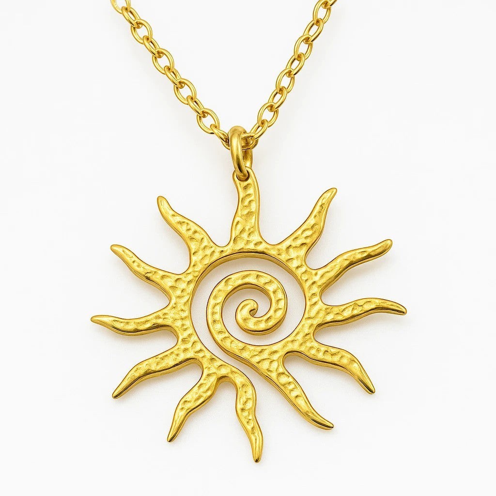 The Velvet Grove gold-tone sun pendant necklace with a textured spiral design on a delicate chain