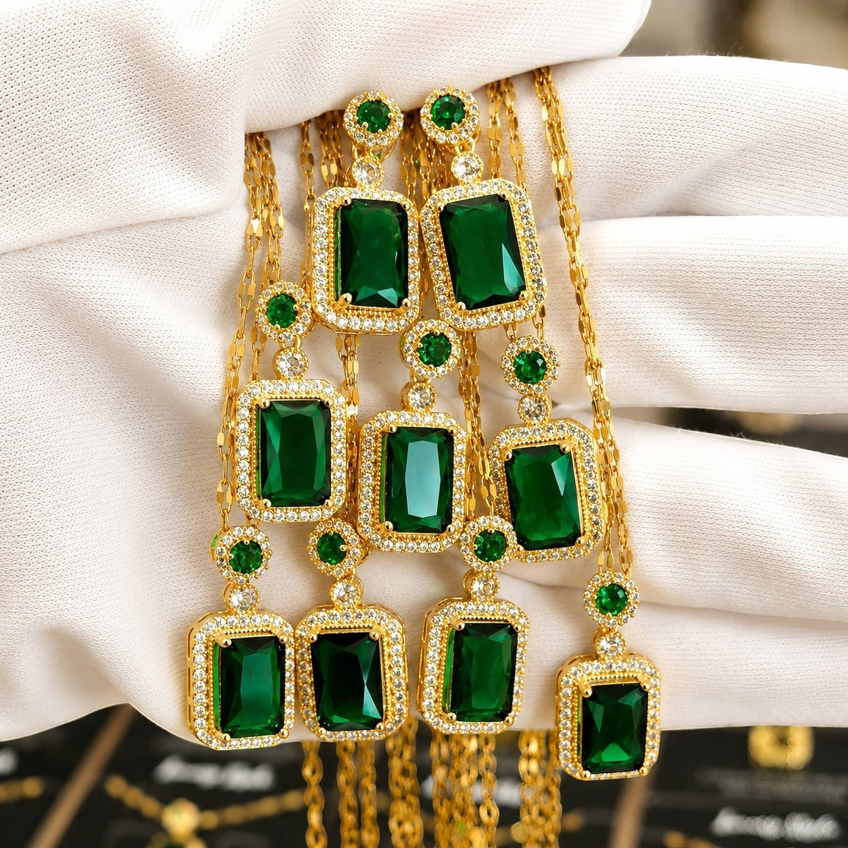 The Velvet Grove emerald green rectangular pendant necklace set with gold-tone chains and clear crystal accents.
