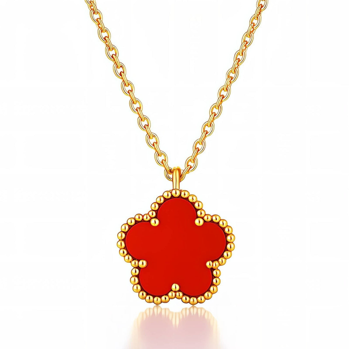 The Velvet Grove red floral pendant necklace featuring a five-petal flower charm with a beaded gold-tone border.