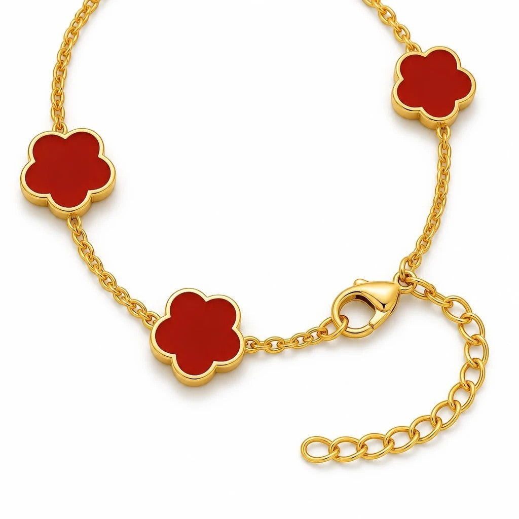 The Velvet Grove gold-tone link chain bracelet featuring vibrant red floral charms with an adjustable clasp.