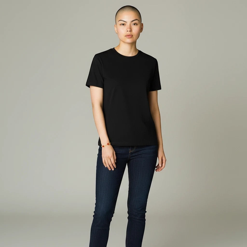 The Velvet Grove ruby red flower charm bracelet on a model wearing a black t-shirt and dark blue jeans