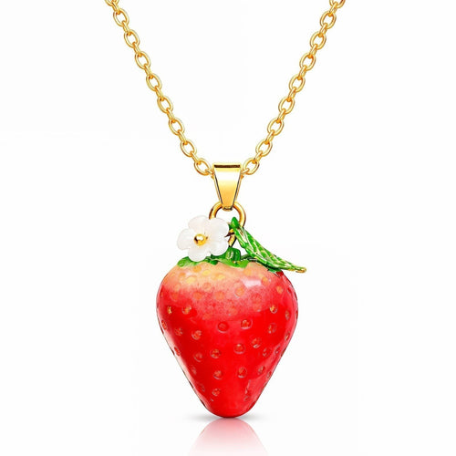 The Velvet Grove strawberry pendant necklace featuring a glossy red fruit with a white flower on a gold-tone chain.