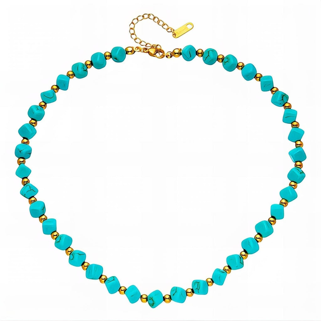 The Velvet Grove beaded statement necklace featuring turquoise-hued beads and polished gold-tone spacers.
