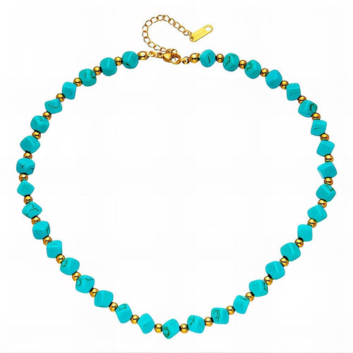 The Velvet Grove beaded statement necklace featuring turquoise-hued beads and polished gold-tone spacers.